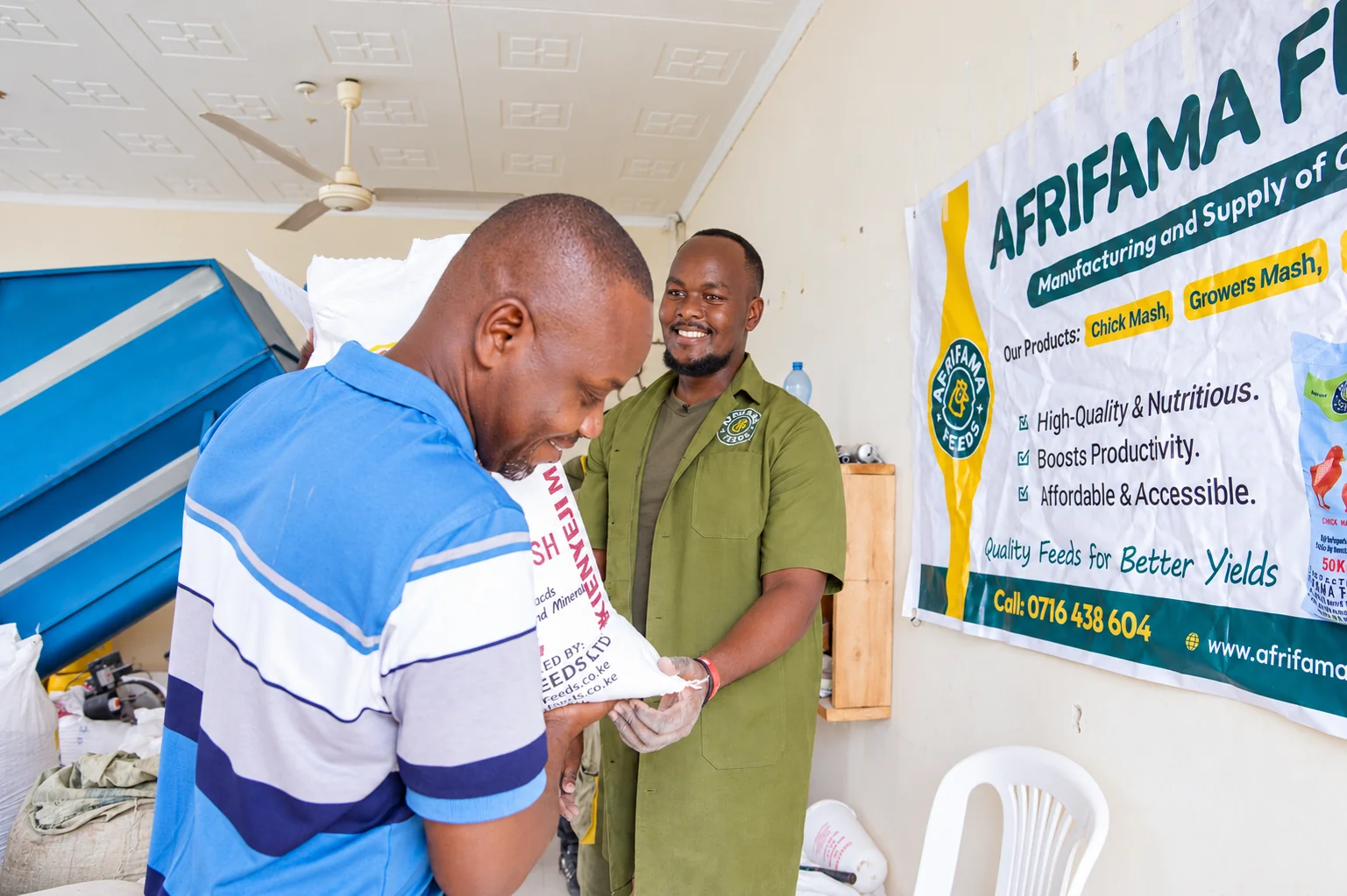 Afrifama team member and visitor reviewing paperwork in the feed facility.